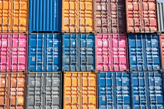 Stacked multicolored shipping containers at a Hamburg port, showcasing industrial logistics.